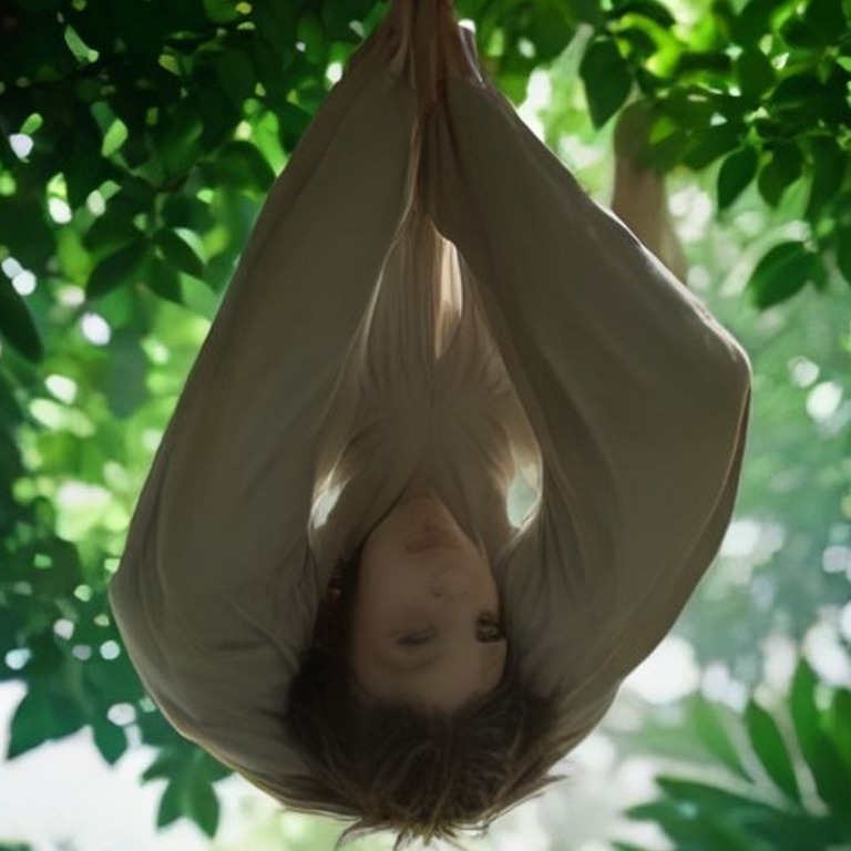 Sloth hanging upside-down from a cecropia branch | ShopAyahuascaRetreats